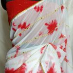 White with red shibori print Georgette  saree  with lace attached paired up with red Georgette sequins embroidery blouse.